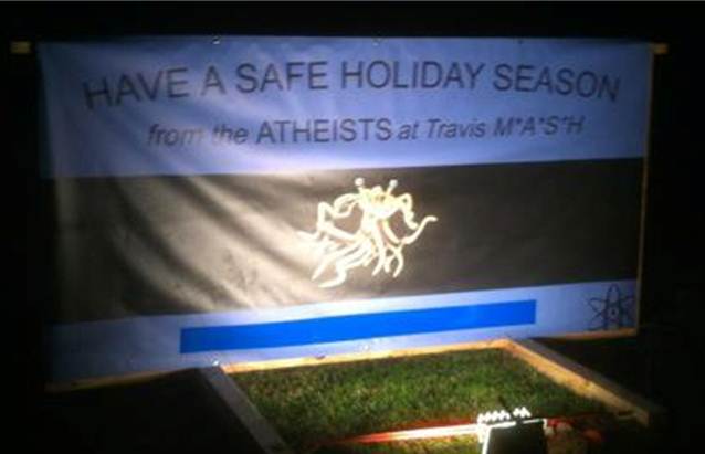 Nighttime scene of the atheist display: "Have a Safe Holiday Season"